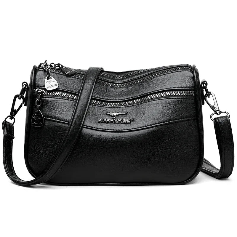 Black leather compact square crossbody bag with gold hardware and double-deck storage.