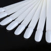 A set of clear acrylic false nail tips for practice and display, arranged in a row.
