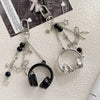 Silver metal music note charms attached to a chain, suitable for bags, keys, or phones.