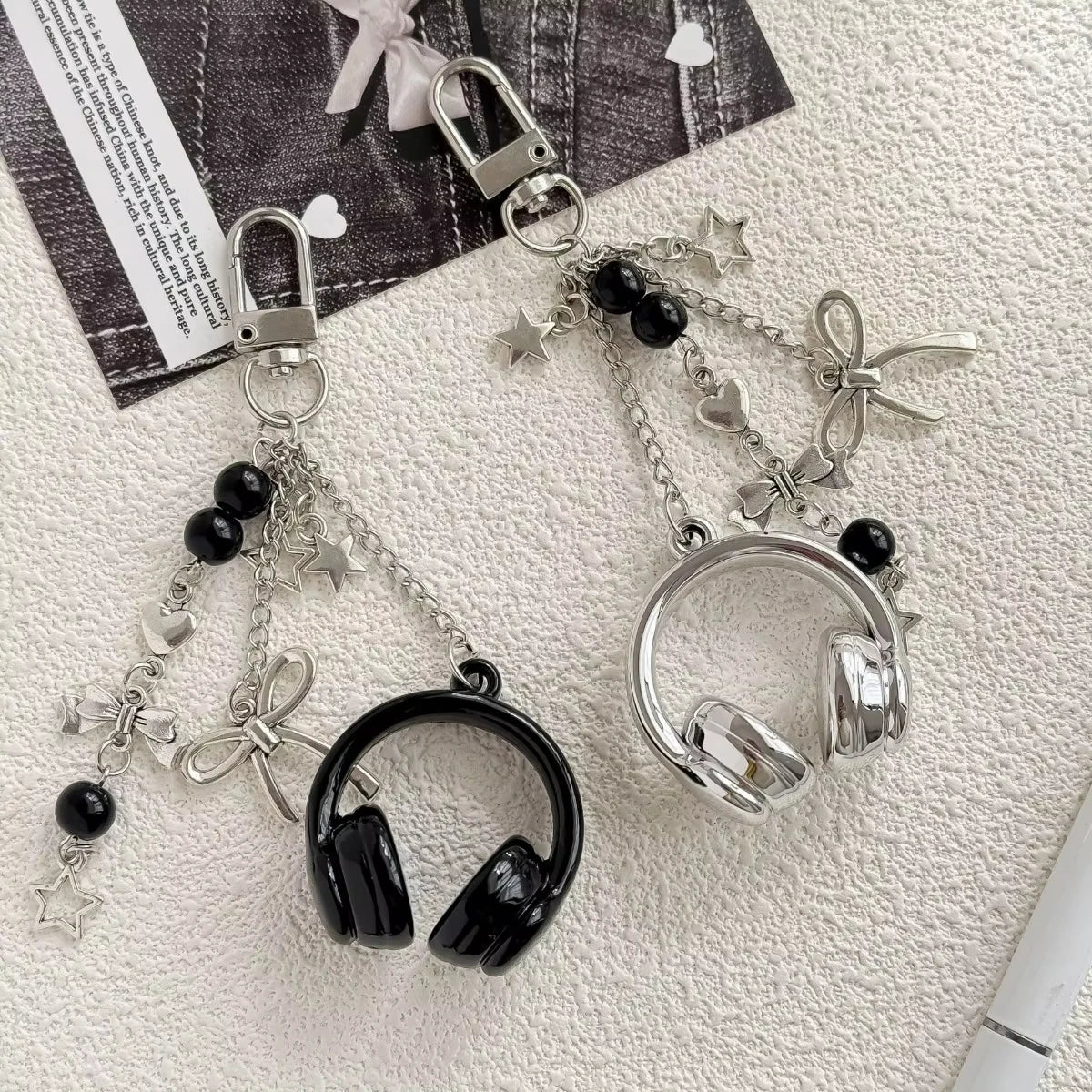 Silver metal music note charms attached to a chain, suitable for bags, keys, or phones.