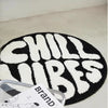 A round black and white letter carpet featuring the word CHILLUBES.