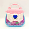 A pink and blue cosmetic playset featuring a butterfly-shaped case with a heart detail and clear compartments.