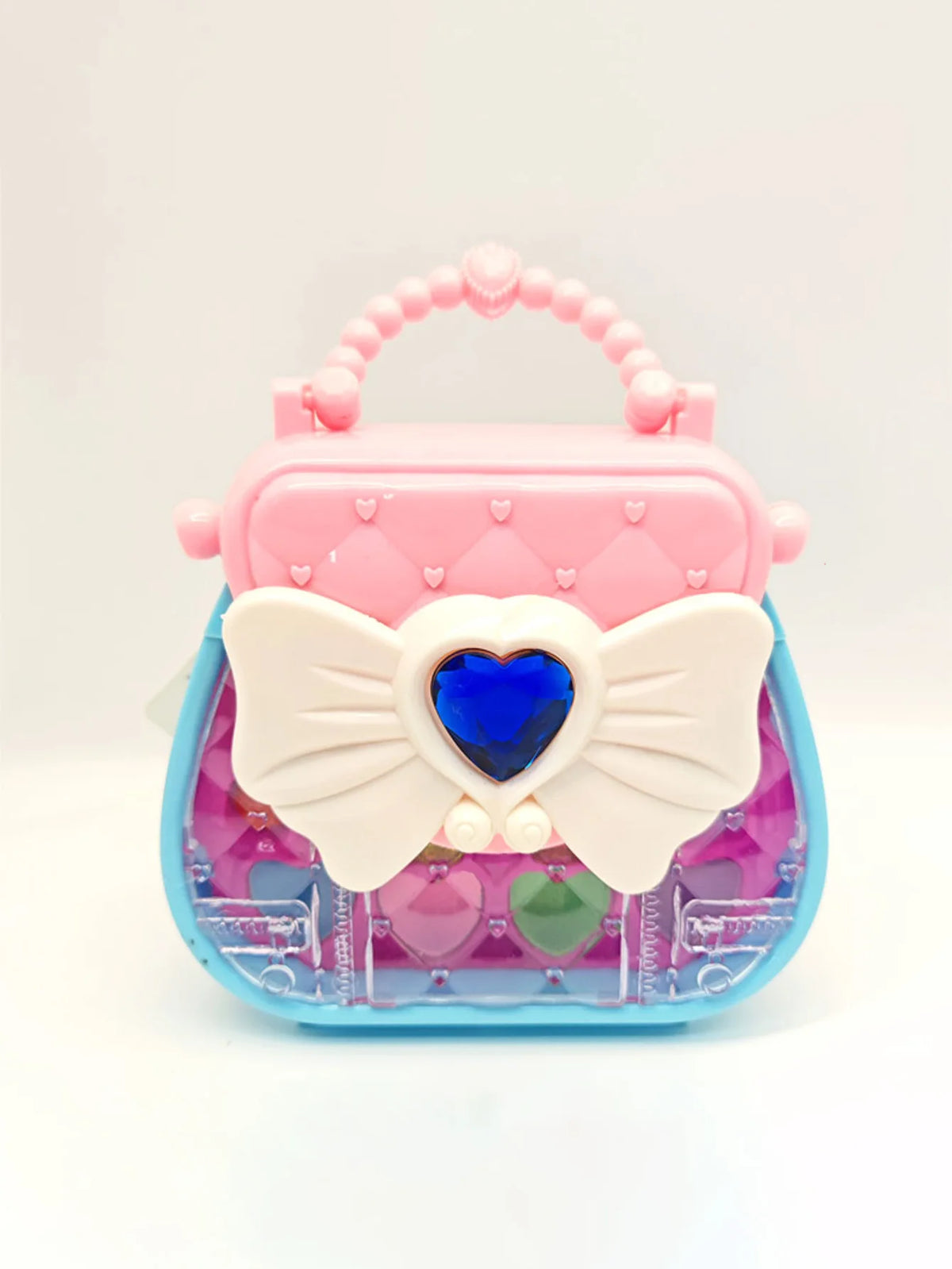 A pink and blue cosmetic playset featuring a butterfly-shaped case with a heart detail and clear compartments.
