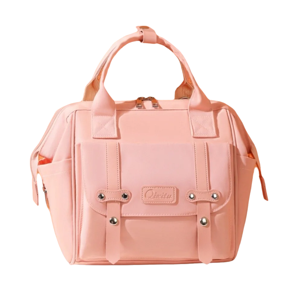 A pink compact diaper backpack featuring a padded front pocket and multiple snaps.