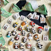 A collection of blind box panda figures in various packaging and colors displayed on a light background.
