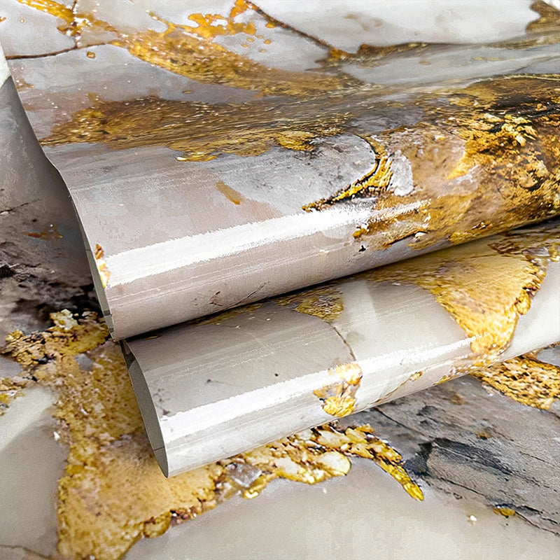 A close-up of golden marble peel-and-stick kitchen backsplash featuring veining and natural stone texture.