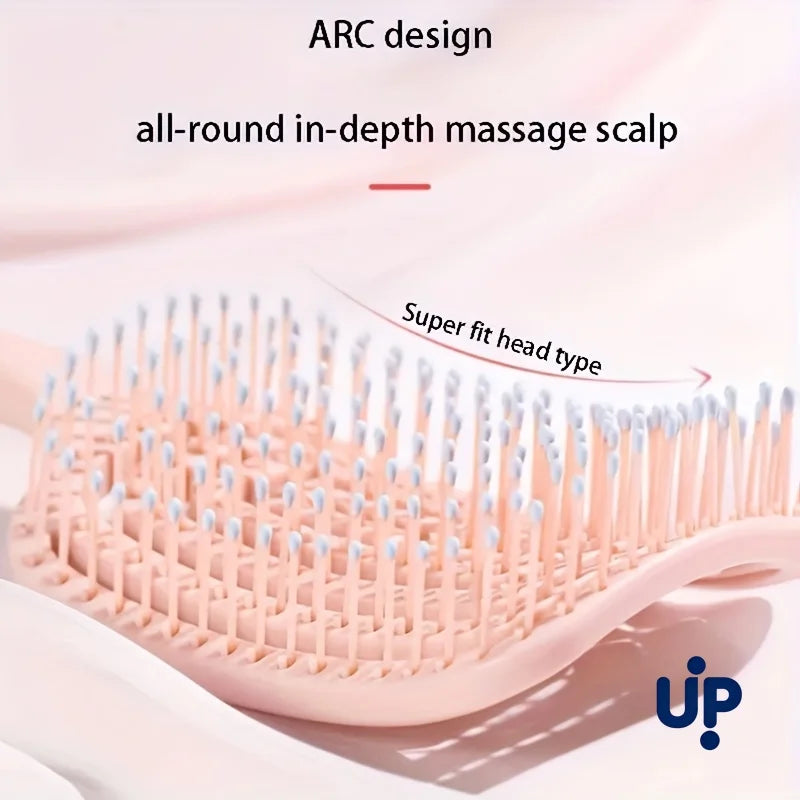 A pink volumizing detangling hair comb with an ARC design is shown on a white background.