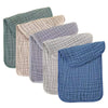 A stack of five colored muslin baby burp cloths in shades of green, beige, purple, gray, and blue.