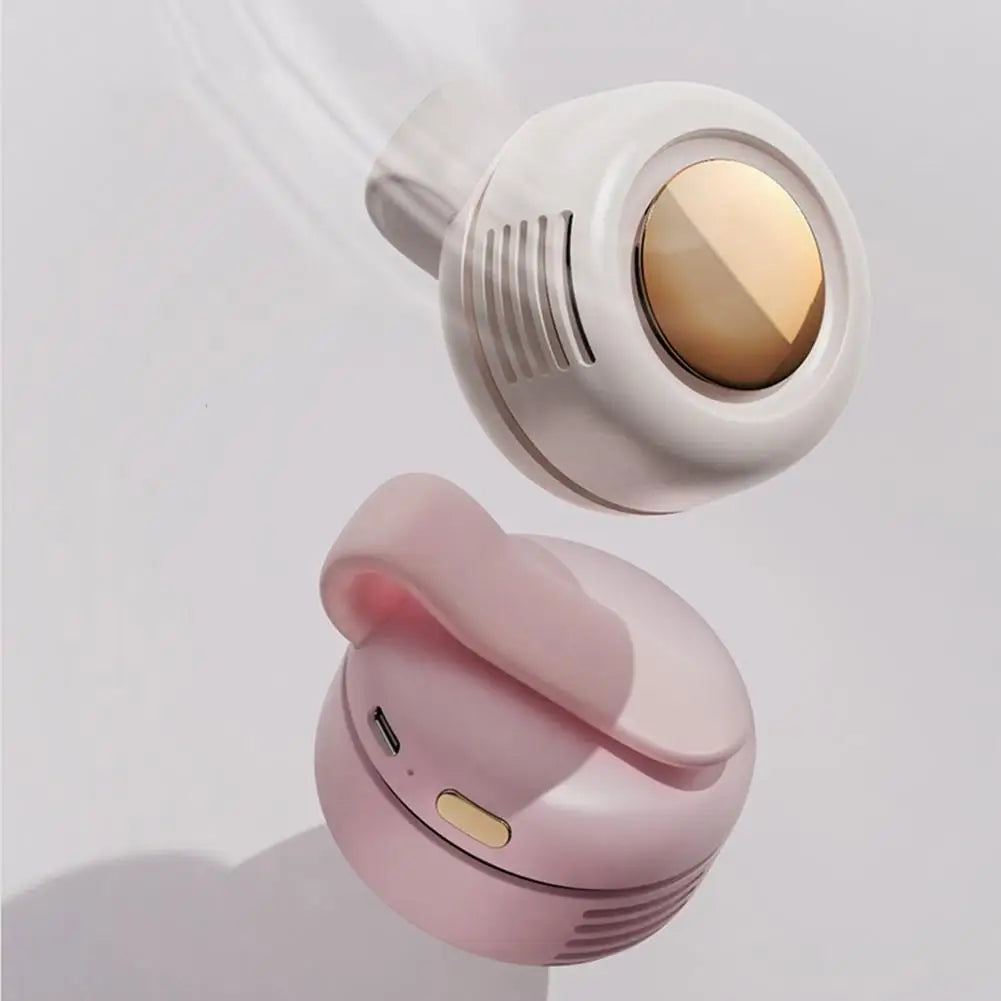 A pink bladeless mini clip-on fan is shown in a close-up view against a white background.