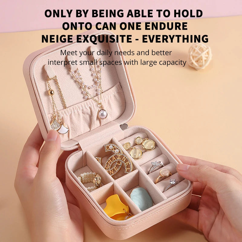 A pink PU leather jewelry storage box is shown open, displaying various pieces of jewelry and accessories.