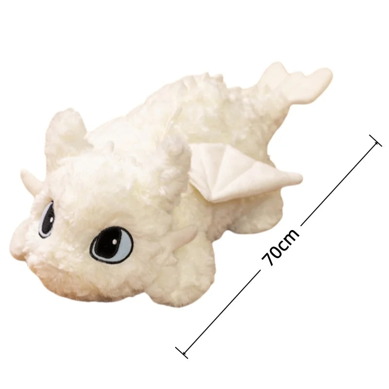 A white soft plush dragon toy resembling a Night Fury with large eyes and wings, shown from the side.