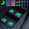 Close-up of a car window switch featuring glow-in-the-dark stickers and a dark panel with illuminated buttons.
