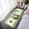 A green banknote pattern anti-slip soft floor mat placed on a gray floor next to a bed.