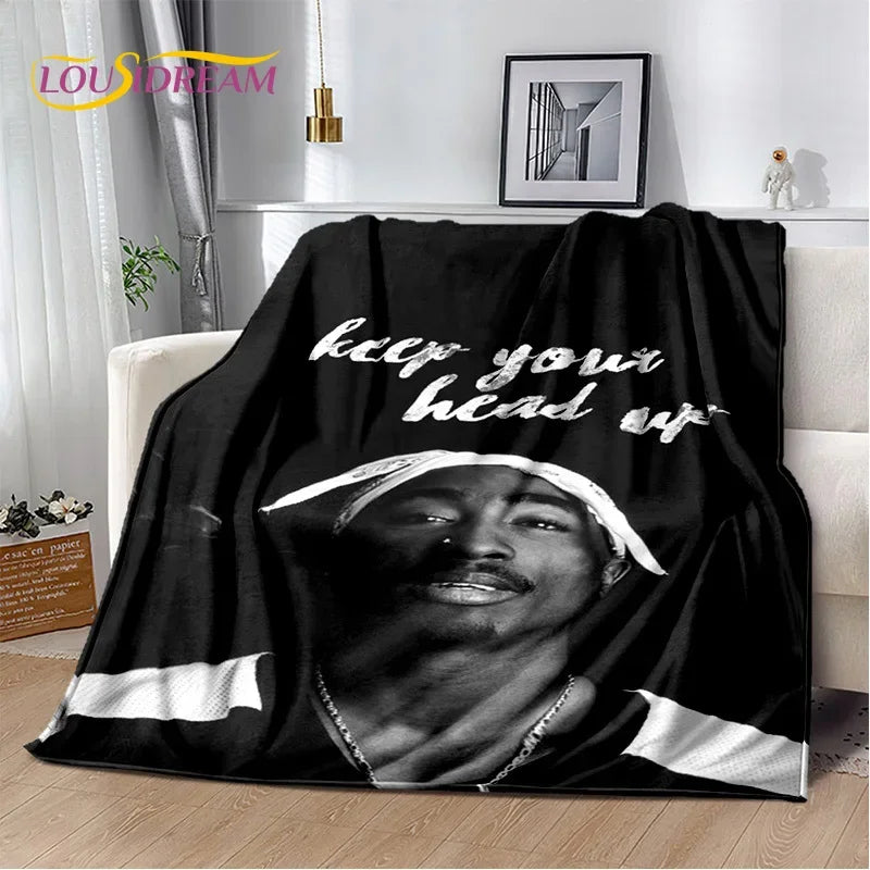 A black throw blanket featuring a portrait of Eminem and 2Pac with the text keep your head up