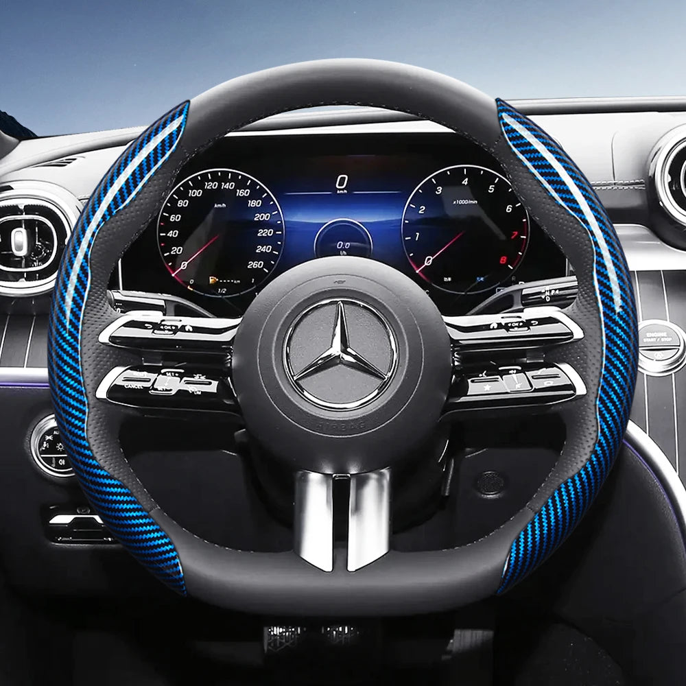 Close-up view of a black steering wheel with blue carbon fiber texture accents and a Mercedes-Benz emblem.
