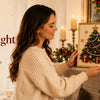 A woman displays a handmade holiday accent, a Christmas tree painting in a frame, for a DIY kit.