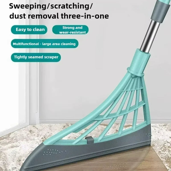 A teal silicone squeegee broom with a long handle is shown cleaning a floor.
