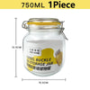 A clear glass mason jar with a yellow lid and a metal clamp, labeled as a steel buckle storage jar.