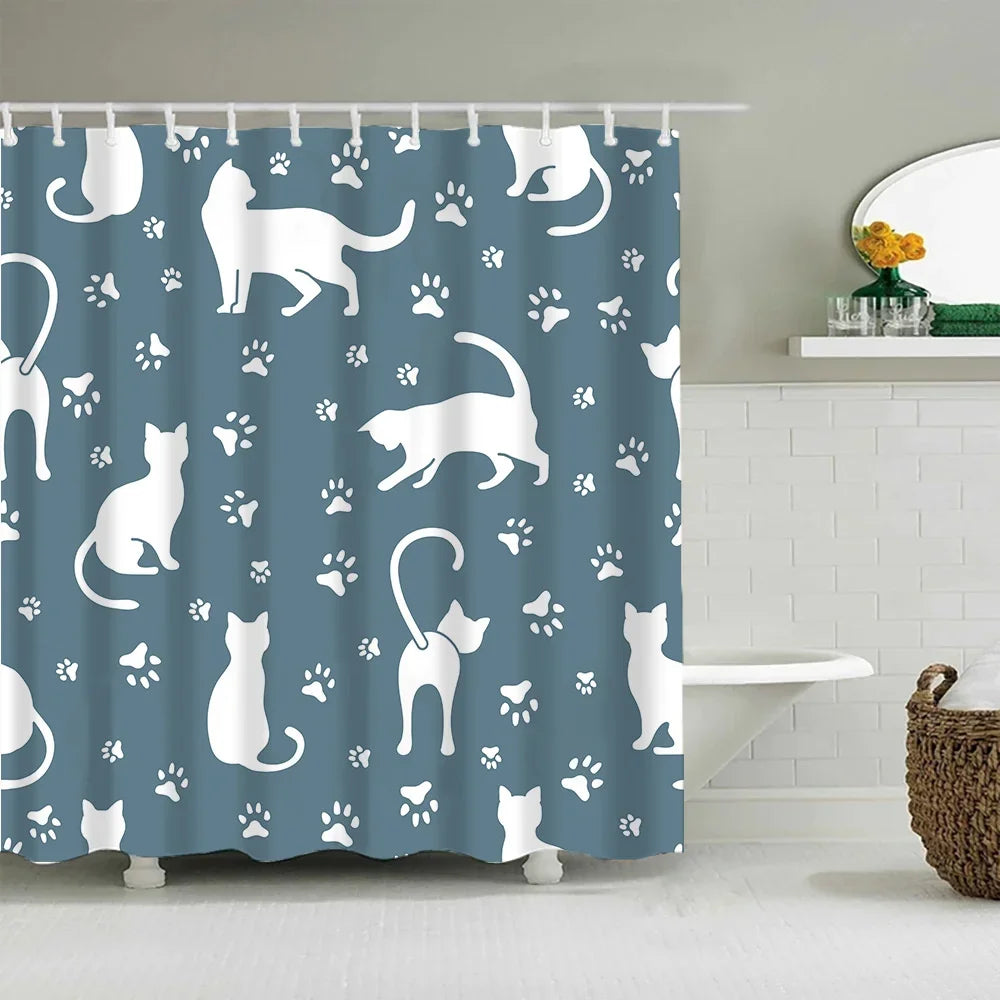 A blue shower curtain featuring a repeating pattern of white cartoon cats and paw prints.