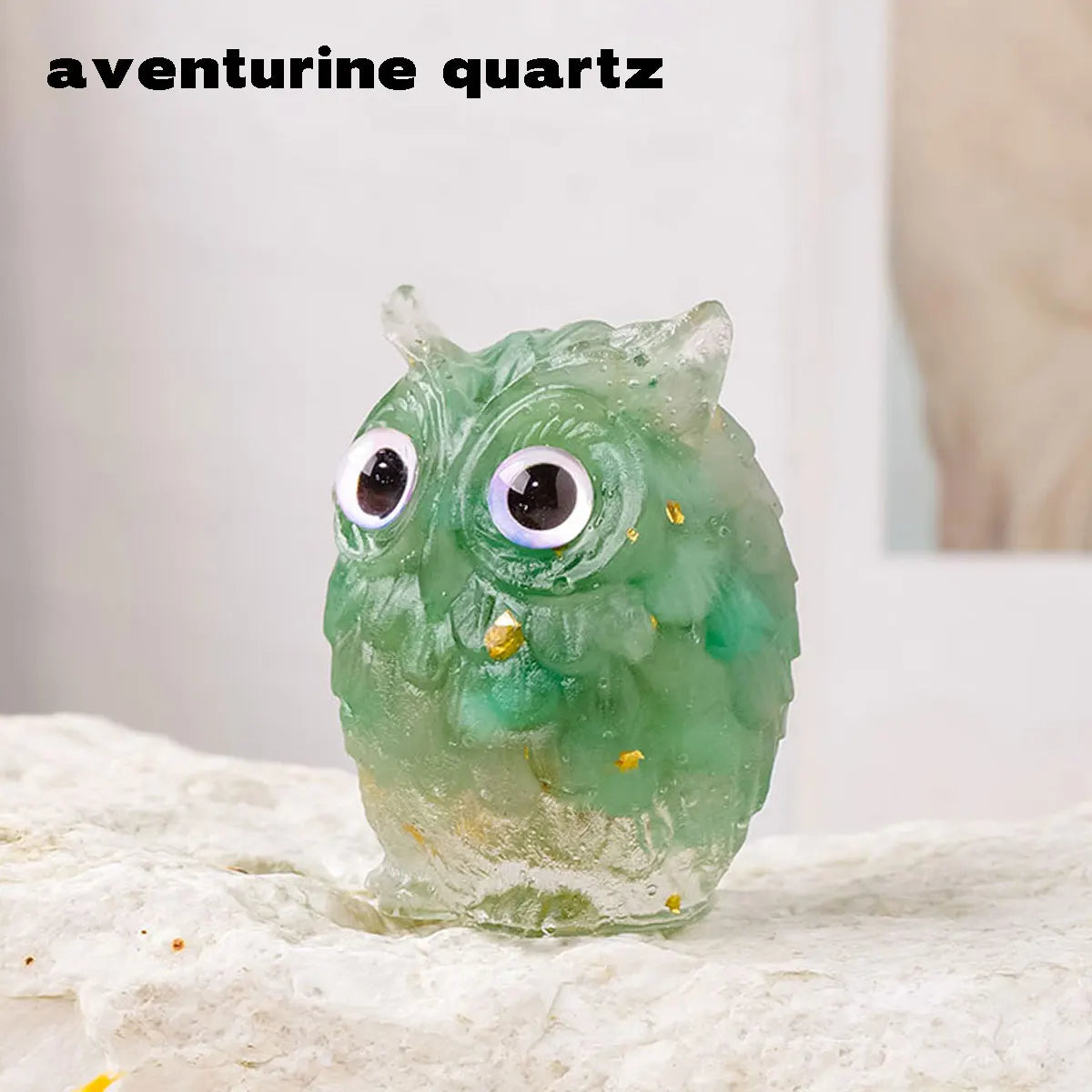 A handcrafted aventurine quartz owl figurine with large eyes and a natural crushed stone finish.