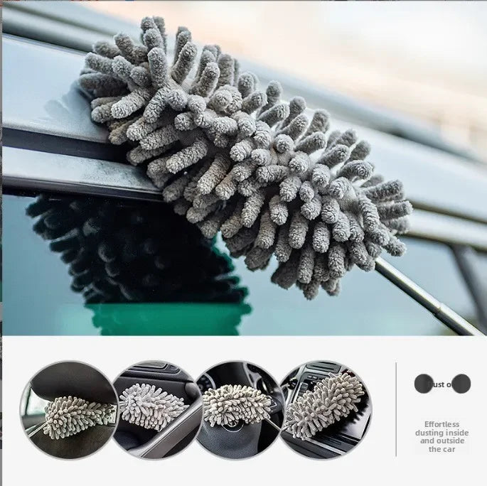 A close-up of a gray microfiber duster with a fluffy head being used to clean the exterior of a car window.