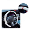 A close-up view of a white steering wheel cover with red accents on a car's steering wheel.