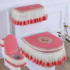 A set of pink and white antibacterial toilet seat covers with washable cushions displayed on a white stand.