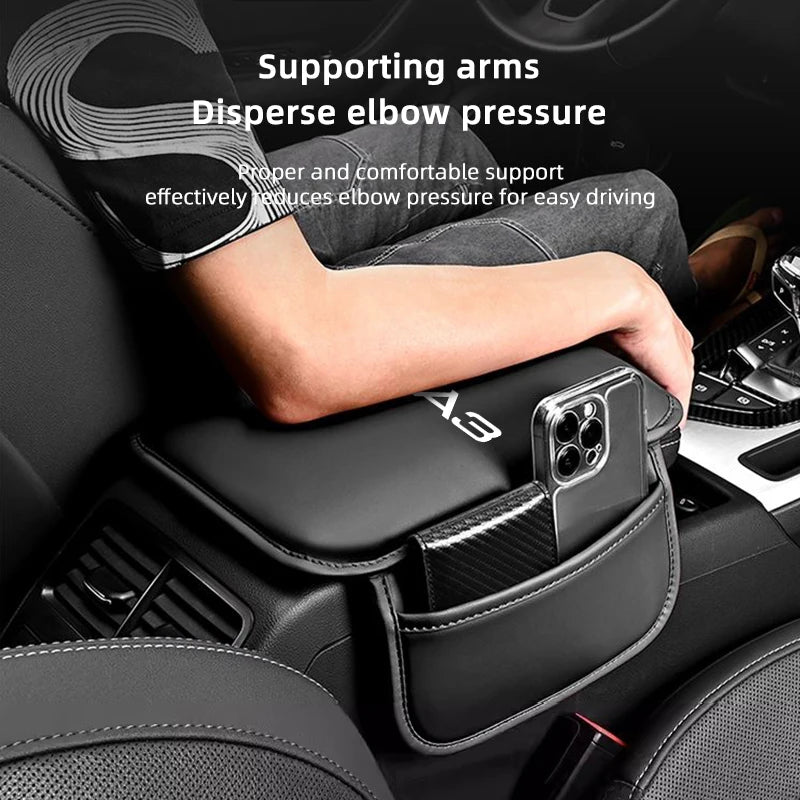 A hand rests on a black car armrest box with a storage pocket, designed to support arms and disperse elbow pressure.