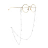 Gold-rimmed round glasses with a delicate silver chain featuring hollow moon pendants