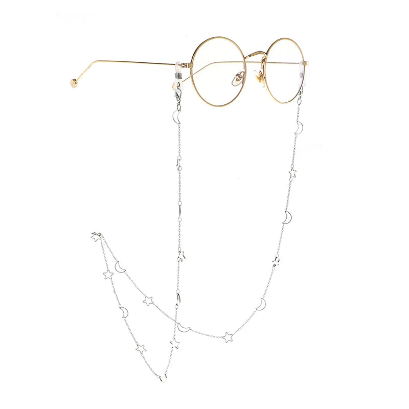 Gold-rimmed round glasses with a delicate silver chain featuring hollow moon pendants