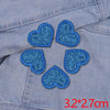 Five blue glitter heart iron-on embroidered patches on a denim fabric.
