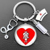 Silver keychain featuring a heart design with a nurse symbol and a medical instrument.