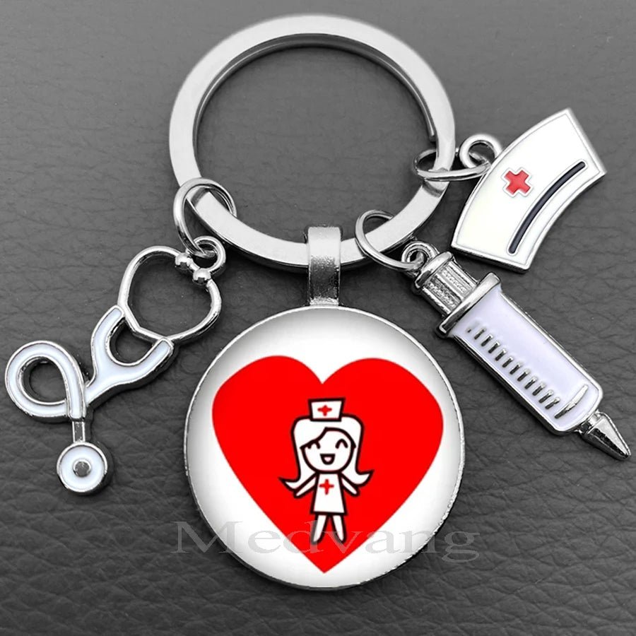 Silver keychain featuring a heart design with a nurse symbol and a medical instrument.