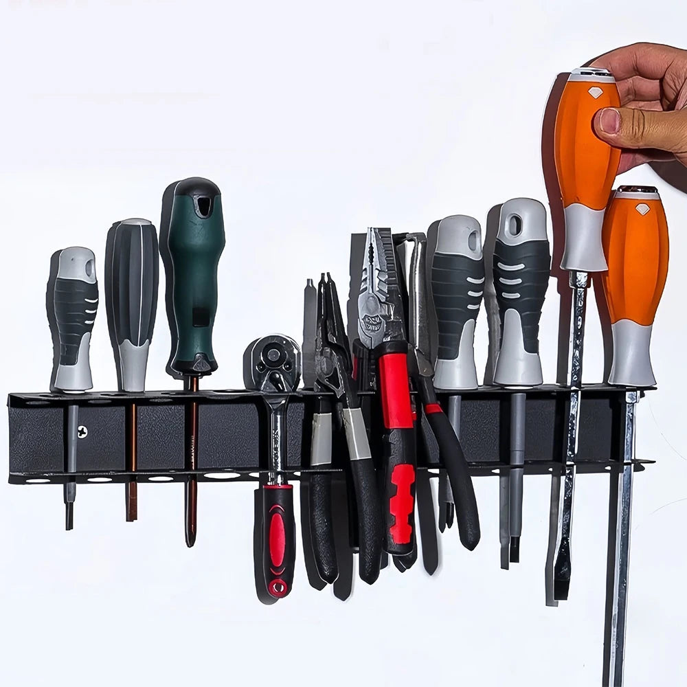 A hand is holding an orange tool from a heavy-duty wall mounted tool storage rack featuring various hand tools.
