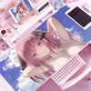 A pink-haired anime girl illustration on a mouse pad featuring a blue sky and clouds.