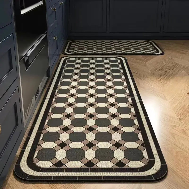 A rectangular kitchen rug with a classic black and beige geometric pattern placed on a light wood floor.