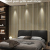 A close-up of a wood grain grille wall sticker used as decorative paneling in a modern bedroom setting.