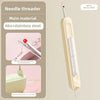 A beige needle threader tool with a sharp point and a plastic handle is shown next to a pink background.