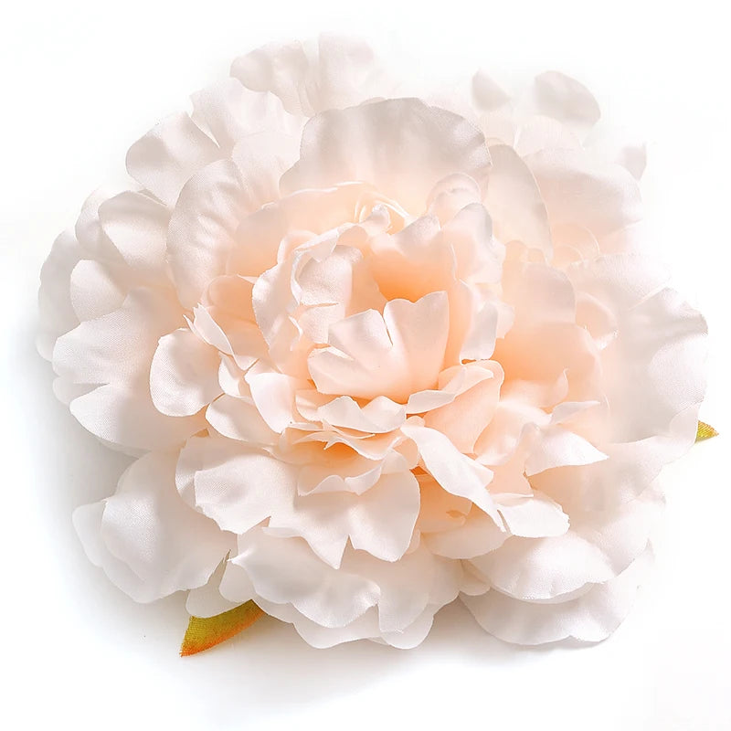 A cluster of soft pink and white silk peony flower heads for crafting and decoration.