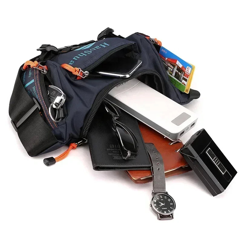 A navy blue tactical chest bag is shown open, containing a smartphone, sunglasses, and a wristwatch.