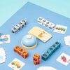 A wooden spelling word game featuring various letters and words like ship, jeep, car, and grape.