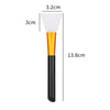 A silicone facial mask brush with a white head and gold handle, shown next to dimension lines.
