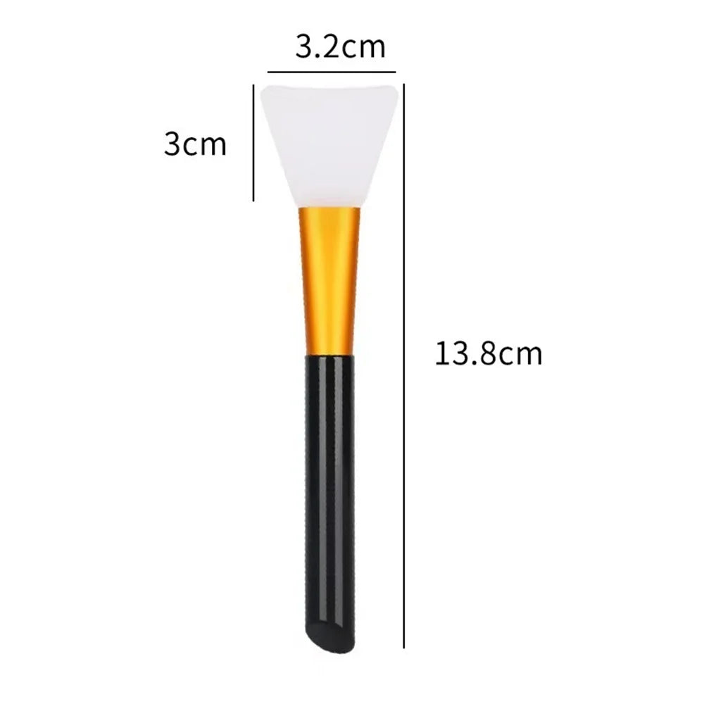 A silicone facial mask brush with a white head and gold handle, shown next to dimension lines.
