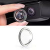 A close-up view of a car camera lens protector, showing the clear glass lens and metal housing.