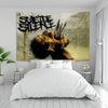 A tapestry featuring the Suicide Silence logo in black and white grunge style, displayed above a white bed.