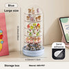 A blue transparent storage box displaying various small collectible figures and keepsakes.