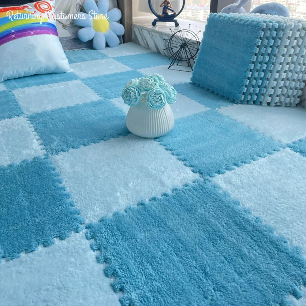 Light blue plush interlocking floor tiles creating a checkered pattern with soft blue pillows and decor