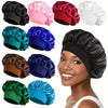 A collection of silk satin sleep bonnets in various colors including black pink red white teal and blue shown on a model's he