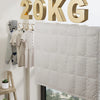 A beige quilted fabric cover for a 20KG retractable clothesline system mounted on a white wall.