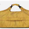 A tan water-resistant duffel bag with a black strap and shoe pocket shown against a light gray background.
